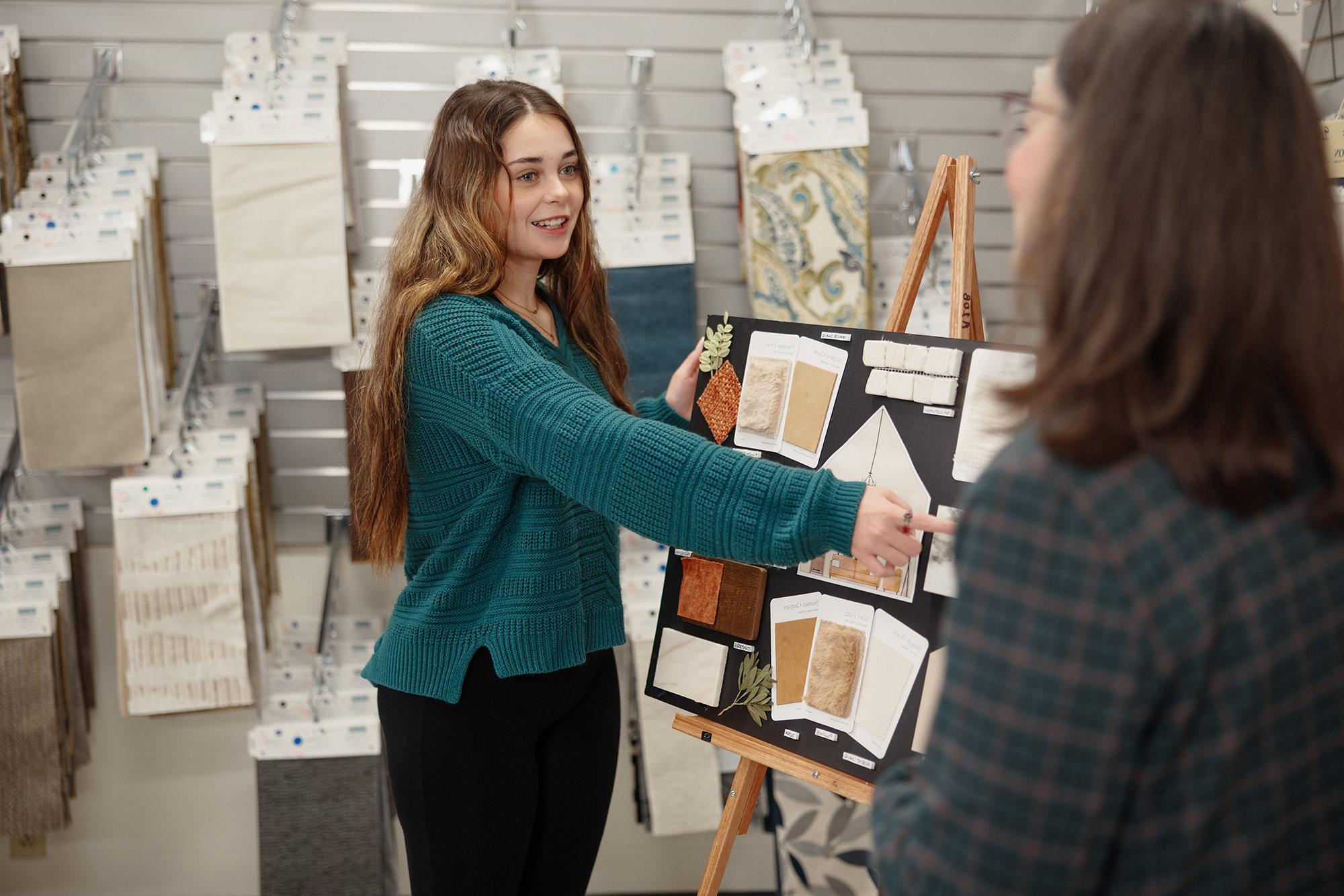 Female designer with a variety of palettes strung out on a table