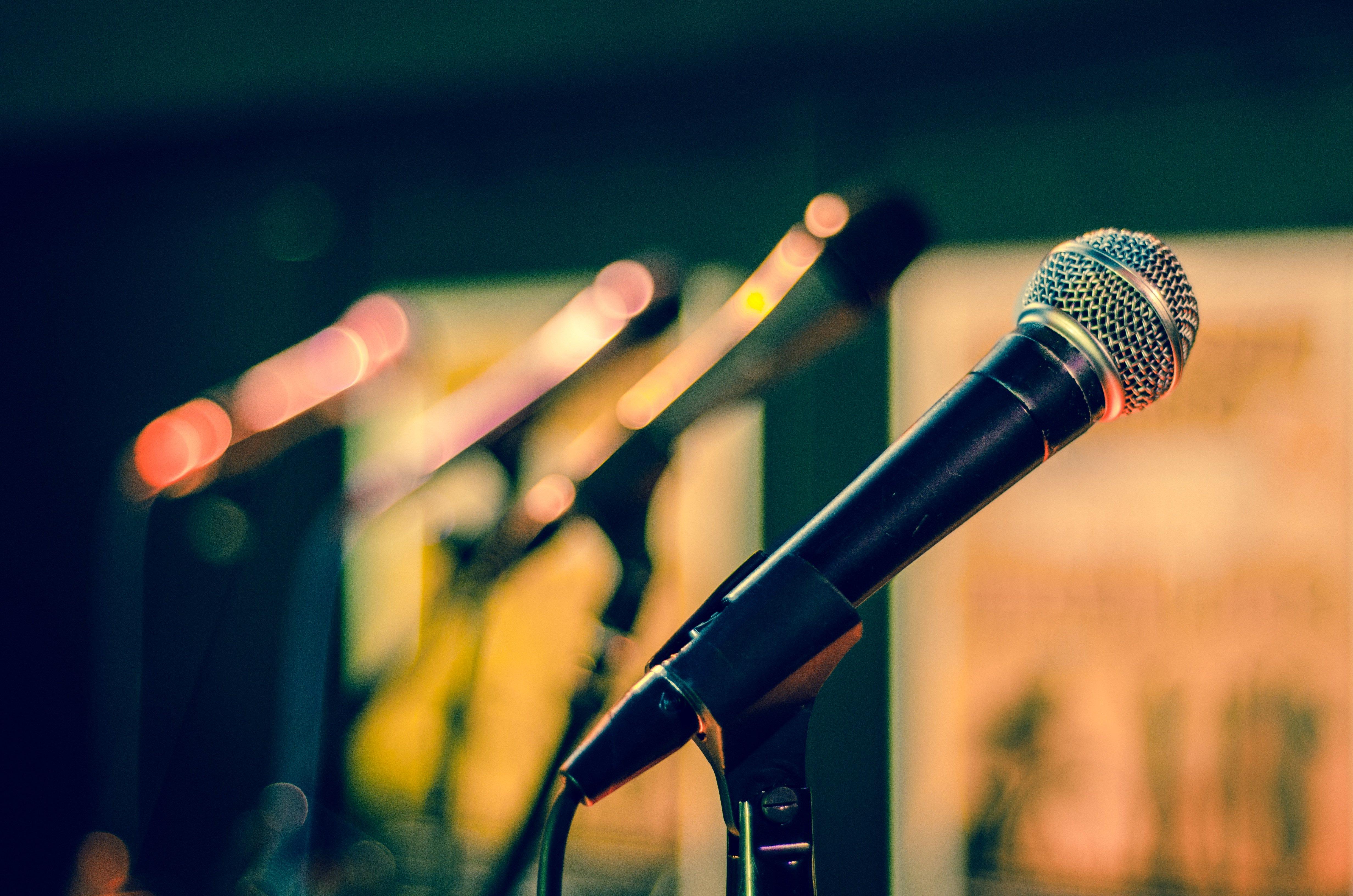 A line of microphones on a stage